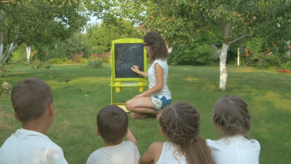 The Woman Teaches the Kids in the Garden