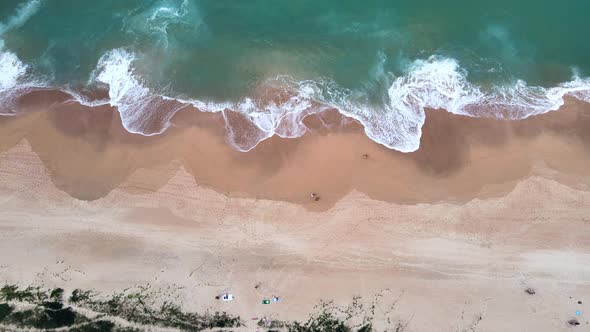 Aerial Top View of a few people enjoying beach time in the south of Brazil. Drone Footage, horizonta