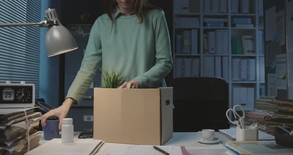 Woman packing her belongings after losing her job