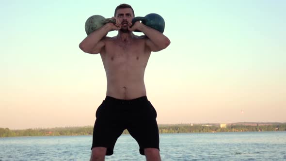 Athlete To Raise Two Dumbbells Over Your Head. Slow Motion