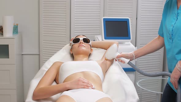 Young Lady Getting Laser Epilation Procedure on Armpits.