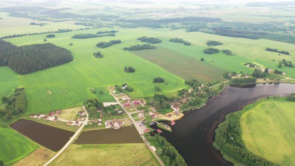 View From the Height of the Lake in a Green Field in the Form of a Horseshoe and a Village in the