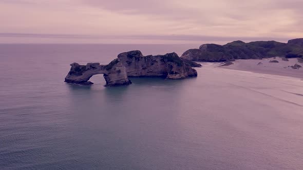 Rock with archway in the evening