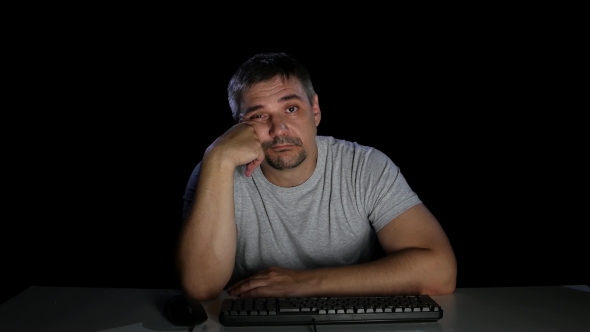 Man with Indifference Looking at a Computer Screen