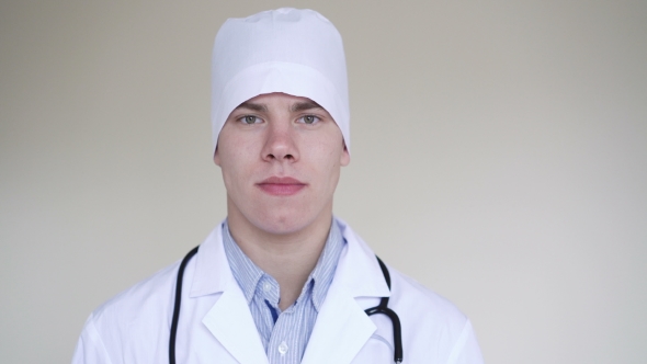 Serious Male Doctor Looking at Camera in