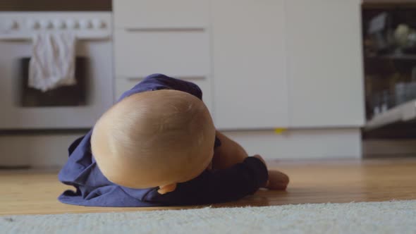 Baby Girl Rolling on the Floor at Home