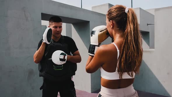 Boxing Training at the Construction Site Young Woman with Her Hair in Ponytail Training Her Punches