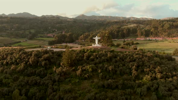 4K daytime before sunset aerial drone view over the imposing statue Cristo Blanco in the city of Cus