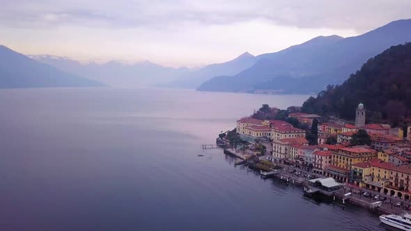 aeraial panning shot of Bellagio in north italy with a view of lake como and the swiss alps in backg