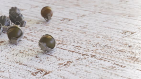 Three types of grenades rolling on a wooden surface. Explosives throw.