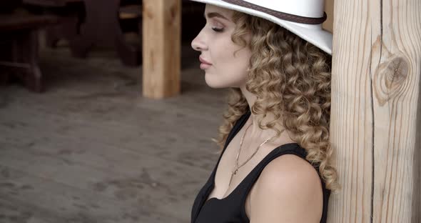 Curly Pretty Girl Wearing A White Hat