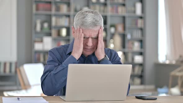 Tired Middle Aged Man Having Headache While Working on Laptop