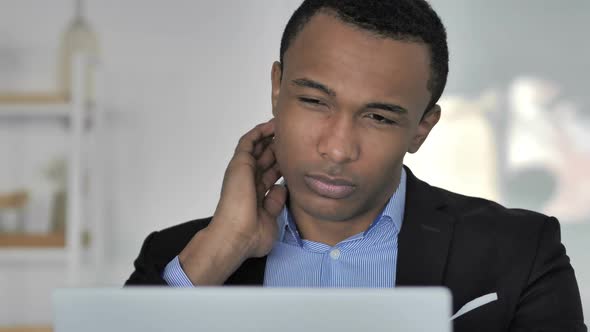 Close Up Of Tired Casual AfroAmerican Businessman with Neck Pain at Work