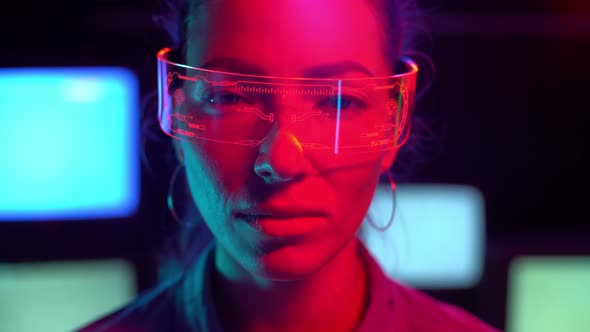 A Close Up of a Caucasian Woman with Smart Glasses Smiling in Front of Camera