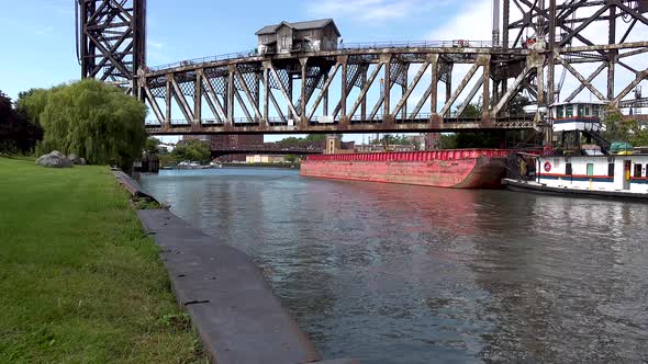 lift bridge with tug and barge on river 4k