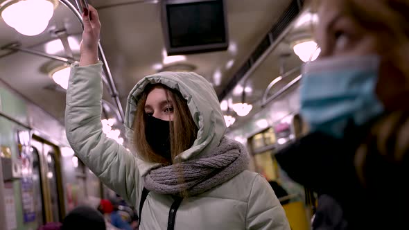 Masked Female in Warm Jacket Riding in Metro Train