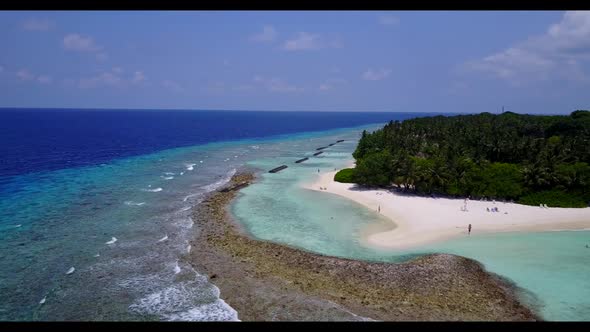 Aerial flying over sky of marine shore beach break by blue ocean with white sandy background of a da