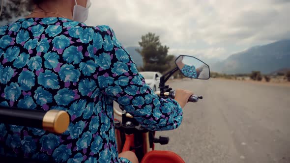 Woman In Face Mask Riding On Scooter On Lockdown Coronavirus. Discovering New Route.