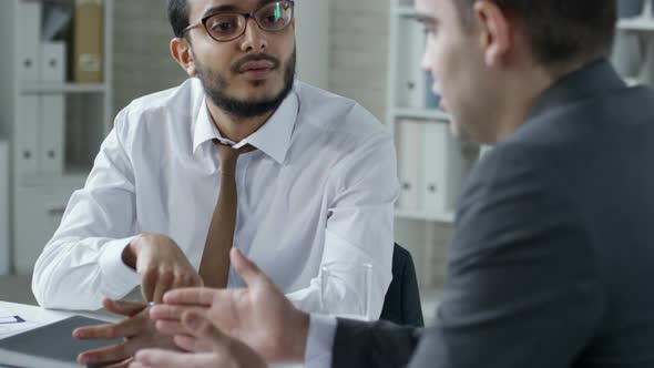 Middle Eastern Entrepreneur Speaking with Business Partner in Office