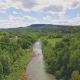 Aerial of a River next to Small Town - VideoHive Item for Sale