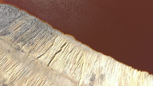 Mine outflow of red acidic water from above 4K aerial video