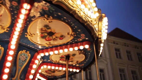 Illuminated Carousel in Old City at Night