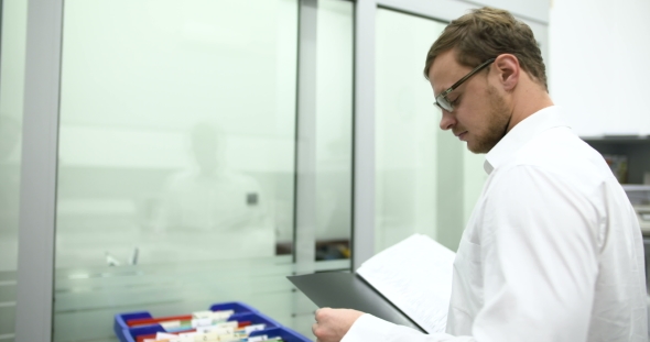 Scientist Holding Documents