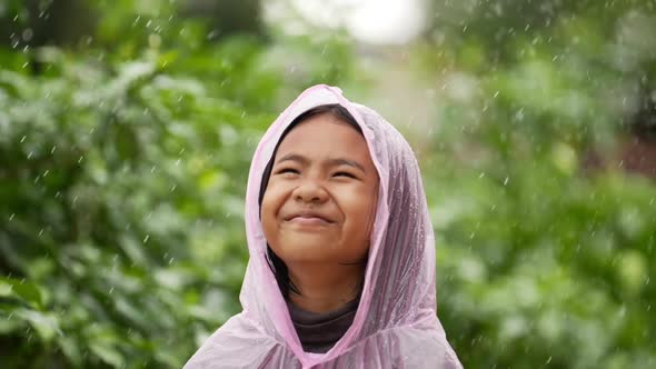 Happy girl wears raincoat