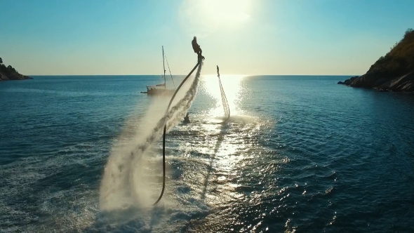 Aerial: Two Men Flying on Flyboard at Sunset