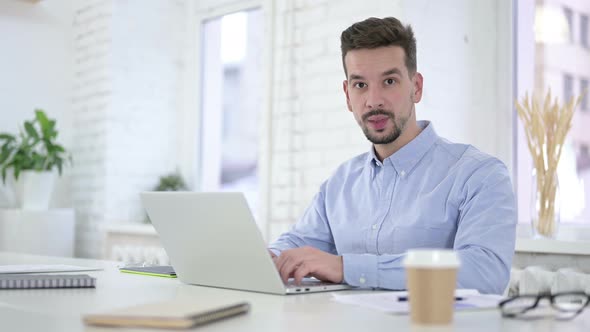 Smiling Man Looking Toward Camera at Work