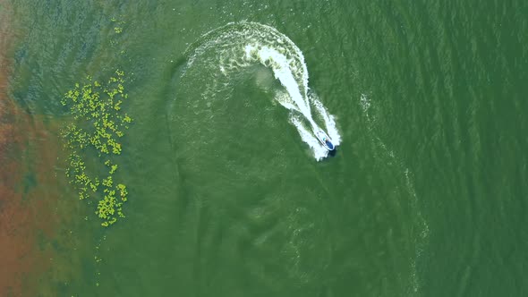 Luxury boat in dark color, fast movement on blue water, aerial view. Expensive luxury Italian boat m