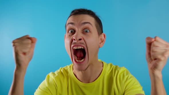 Anger is an Emotion of a Man Face in Closeup on a Blue Background