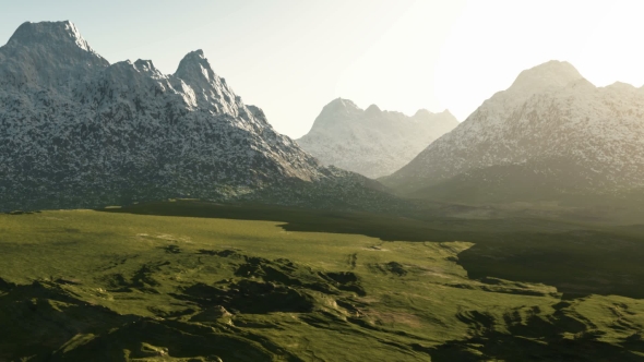 Green Valley and Mountains in Snow at Sunset alt