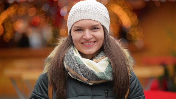 Portrait of a Beautiful Smiling Young Woman Wearing Warm Clothing. Girl Laughing and Looking at the