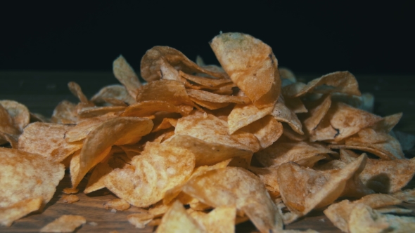 Potato Chips Rotating On Black Background