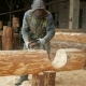 Man Cuts Wood Chainsaw for Future Home. Protective Face Mask on the Face of the Builder and a Lot of - VideoHive Item for Sale