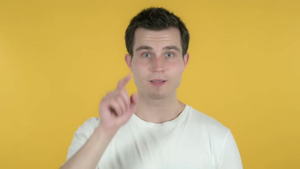 Man Pointing at Camera, Yellow Background