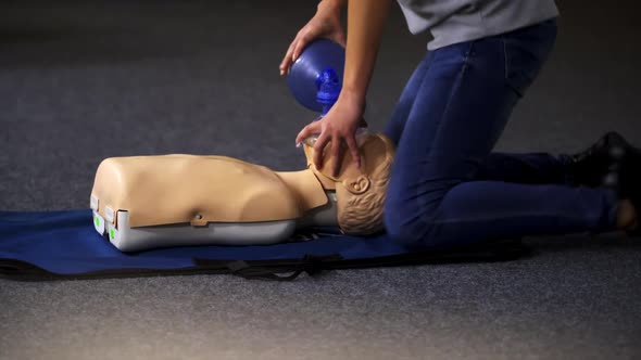 Medical doll lays on blue blanket ready for training. 