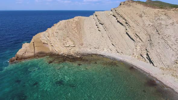 Clear Sea Water of the Promontory Headland Surrounded by Stone and Rocky Coastline