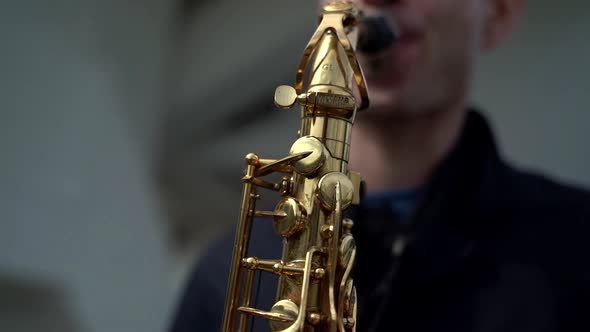 Saxophone in Hands of Young Skilled Musician, Man Is Playing Song on Instrument