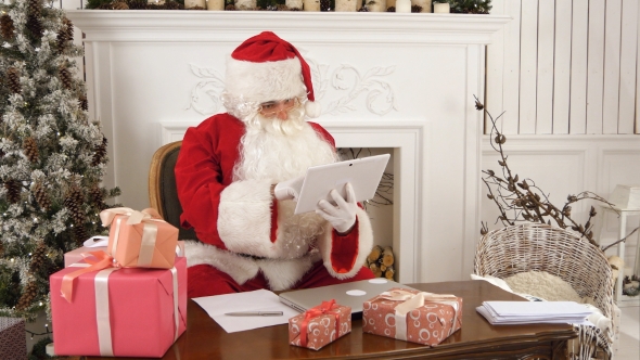 Santa Claus Using Tablet To Give a Quick Video Call To the North Pole