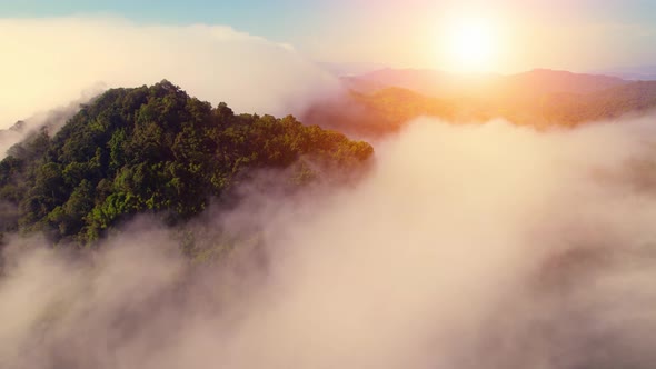 Drone flying above the clouds during sunrise