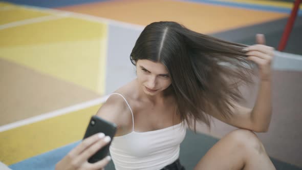 Portrait of Young Happy Basketball Player Taking Selfie on Smartphone