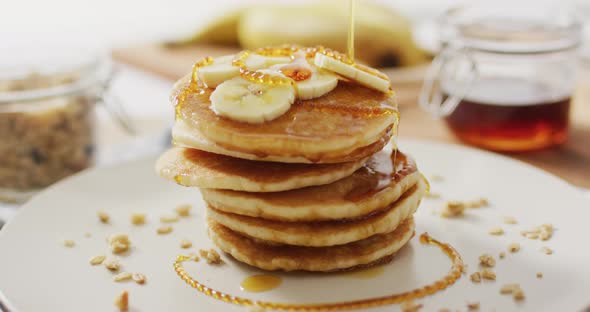 Video of pancakes on plate seen from above on wooden background