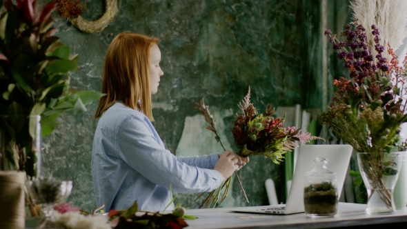 Florist Composing Bunch of Flowers Near Computer