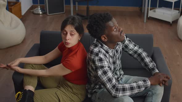 Young Interracial Couple Fighting on Couch at Home