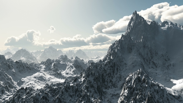 Mountains in Snow and Clouds at Blue Sky