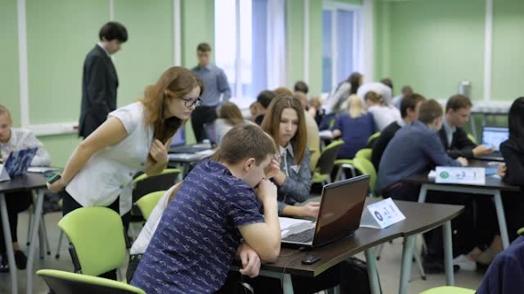 Students at the University on the Exam on Computer Science. In the Large Audience a Lot of People