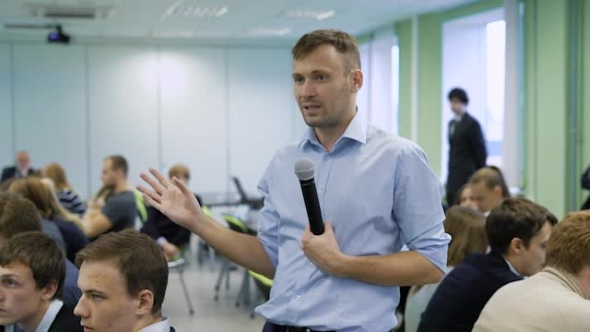 Renowned Speaker Speaks at a Business Conference in Front of a Full Hall Managers