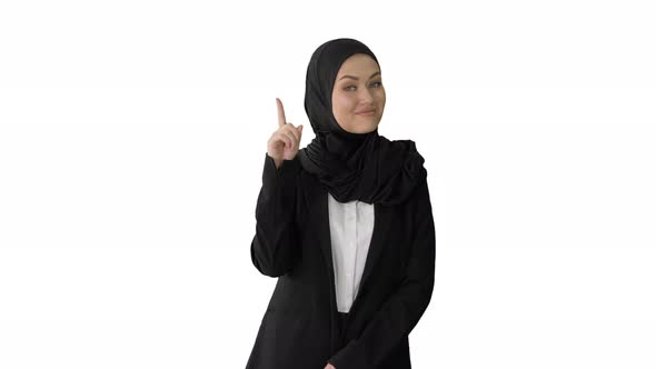 Arab Businesswoman in Hijab Raising Finger and Nodding Head in Approval on White Background.